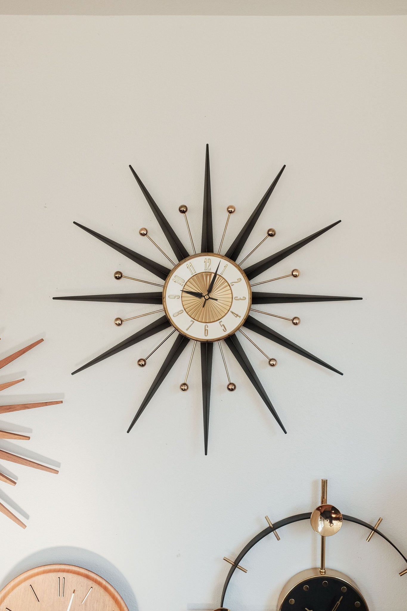 Vintage Mid Century Elgin Starburst Clock Black metal and Brass